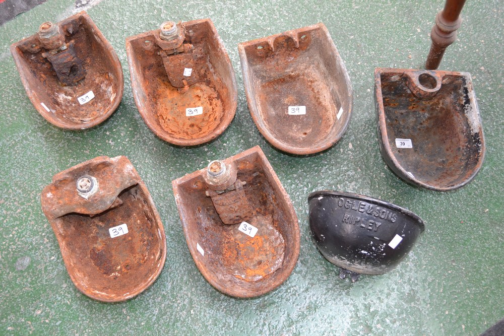 Seven cast iron wall mounted cattle troughs including Ogle & Sons,