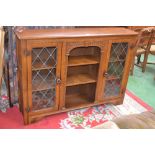 An oak bookcase with glazed leaded light