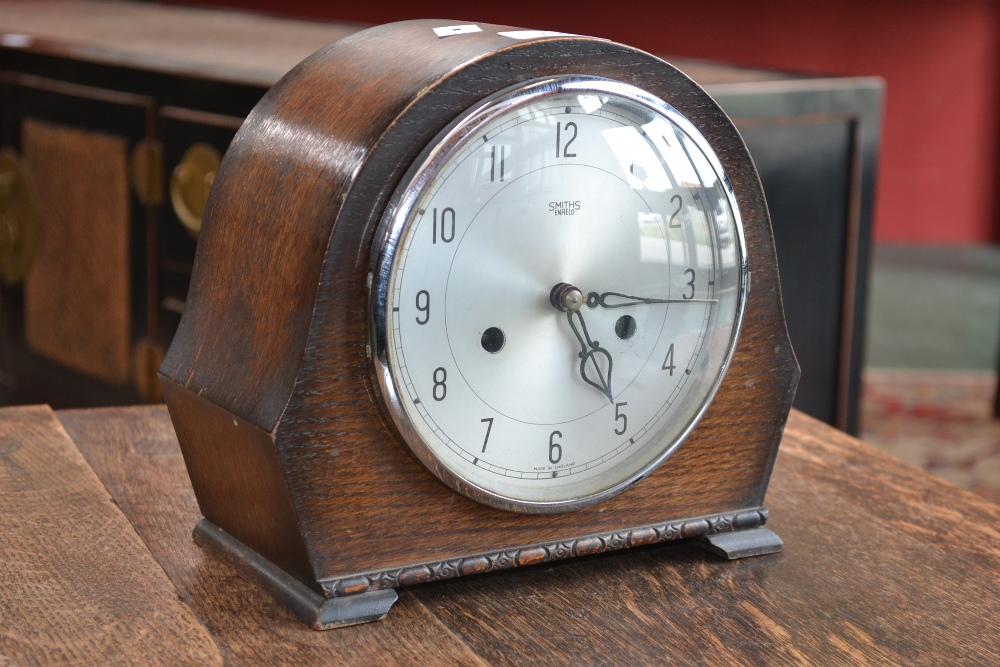 A Smiths oak cased chiming mantel clock, silvered dial, Arabic numerals,