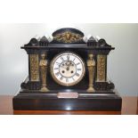 An Edwardian Ashford slate and brass mantel clock, architectural case, classical mask and columns,