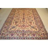 A Tabriz carpet, woven in shades of red, blue and gold, 2.76m x 1.