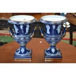 A pair of contemporary classical style two handled urns in the Minton pate sur pate style