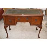 An early 20th century oak knee hole desk