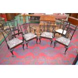 A set of six Chippendale style dining chairs including two carvers, shaped top rail,