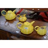 A Carlton ware tea pot and milk jug in yellow,