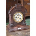 An American Ansonia Mantel clock, shaped arch top oak case, white and gilt dial, Roman numerals,