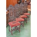 A set of four Jacobean revival oak side chairs, the backs profusely carved with foliage,