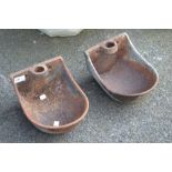 Two cast iron wall mounted feeding troughs