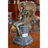 A bronze figure, study of a young lady, she sits a top marble column admiring her reflection,