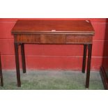 A mahogany tea table, rectangular fold over top, hidden drawer to frieze canted fluted supports.