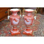 A pair of contemporary continental two handled urns in the Minton pate sur pate style,