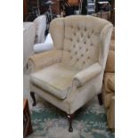 An upholstered armchair, cabriole legs,