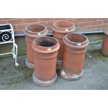 A set of four circular Victorian chimney pots