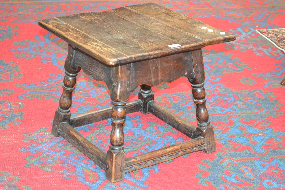 An oak side table with turned supports