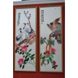 A pair of oriental embroidered silk panels with cranes and flowering peonies, eagles with hibiscus.