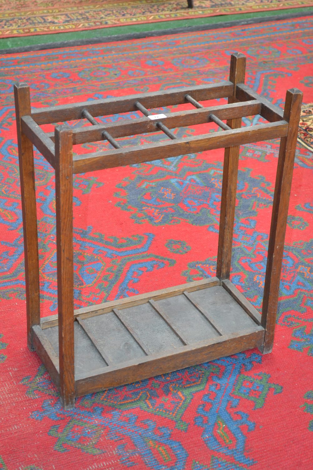 An oak rectangular stick stand with tray