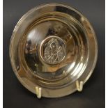 An Elizabeth II silver circular dish, of Armada form,