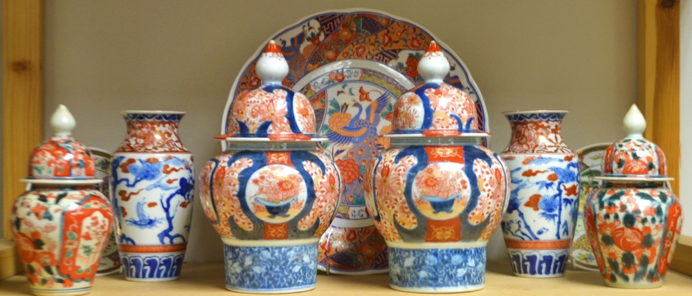 A pair of late 19th century Japanese Imari palette inverted baluster jars and covers;