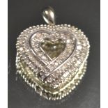 A 9ct white gold love heart shaped pendant, set with an arrangement of baguette cut diamonds,