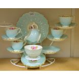 An Aynsley pink rose tea service comprising, cake plate, five tea plates, four cups, five saucers,