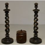 A large pair of treen twisted candlesticks,