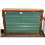 A mahogany glass front wall display cabinet, with six glass shelves.