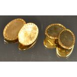 A pair of 9ct yellow gold oval platform cufflink's, plane matrix, C scroll border, Birmingham 1965,