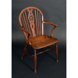 A 19th century elm wheel back Windsor elbow chair,