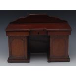 An early Victorian mahogany novelty tea caddy, as an inverted break centre pedestal sideboard,