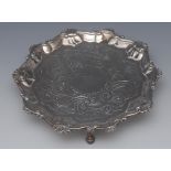 A George III silver shaped circular card waiter, shell and S-scroll border,