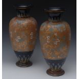A pair of Royal Doulton ovoid vases, painted with stylized flowers and scrolls in turquoise,