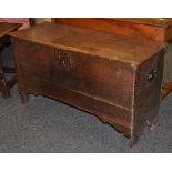 An early 18th century oak six plank box, hinged cover, iron hinge and lock plate,