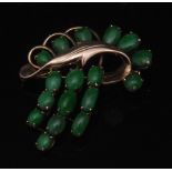 A dyed green jade and 14ct gold brooch, stylised floral spray,