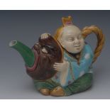 A late Victorian Minton majolica teapot,  in the form of a Chinaman astride a mythical beast,