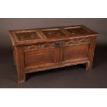 An early 18th century  oak blanket box, three panelled top, lunettes to frieze, two panels to front,