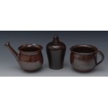 A 19th century salt glazed stoneware money box, acorn finial, 16cm high;  a similar posset pot,