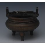 A Chinese bronze ding tripod censer, angular lug handles, tall serpentine legs,