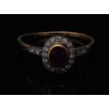 A ruby and diamond ring, central oval red ruby,