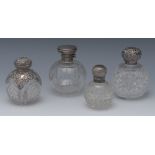 A George V silver mounted clear glass globular scent bottle, cut with swags and pendants, 11cm high,