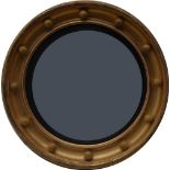 A Regency giltwood circular convex looking glass,