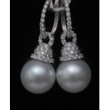 A pair of diamond and pearl drop earrings, each with a large single grey/white globular pearl,