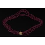 A graduated five-strand necklace of faceted ruby beads,