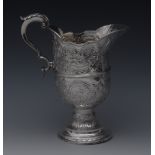 A George III silver helmet shaped ewer, acanthus capped double-scroll handle, centre girdle,