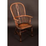 An early 19th century yew and elm Windsor elbow chair,