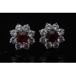 A pair of ruby and diamond cluster earrings, each with a central ruby, approx 0.