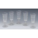A set of five clear glass champagne flutes,  horizontal slice and facet cut bucket shaped bowls,