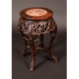 A Chinese hardwood stand, circular top set with rouge marble panel, deep sides,