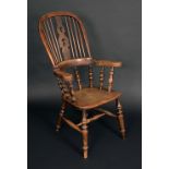 A 19th century elm Windsor elbow chair, tall hoop back with shaped and pierced splat,