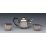 A George VI silver three piece canted boat shaped tea service, comprising teapot,