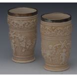 A pair of Doulton Lambeth silver mounted beakers,